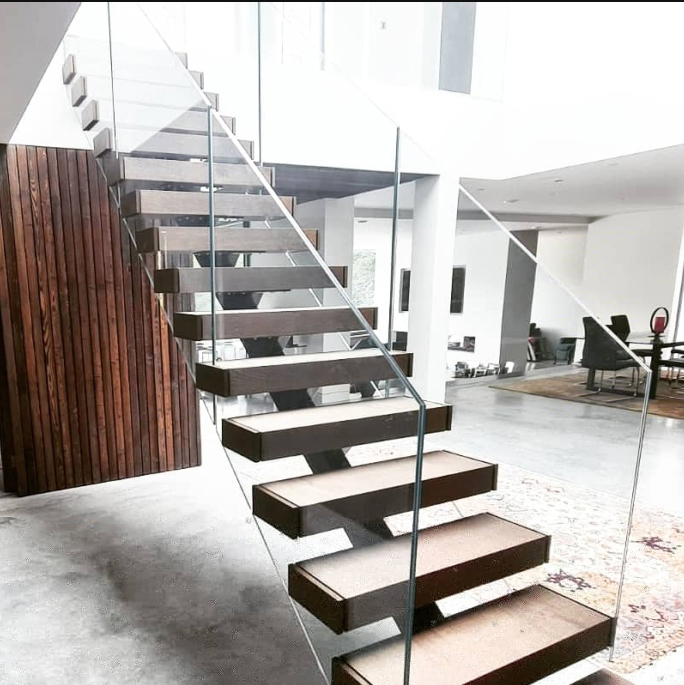 Frameless glass railing system installed on a modern staircase