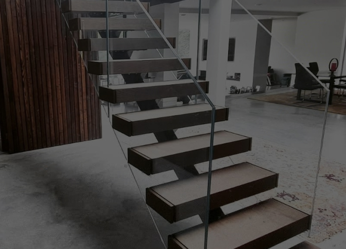 Frameless glass railing system installed on a modern staircase
