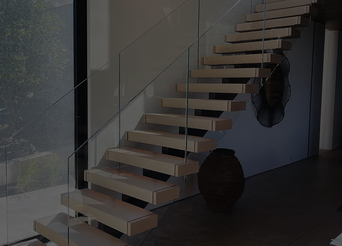 Semi-frameless glass railing installed on residential staircase