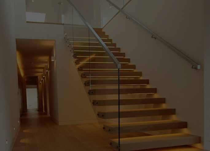 Top rail glass railing installed on modern staircase