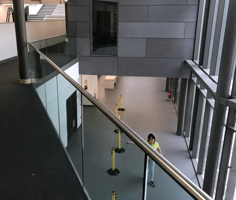 Top rail glass railings in shopping mall