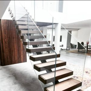 Frameless glass railing system installed on a modern staircase